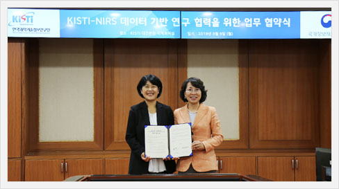 김명희 원장이 한국과학기술정보연구원장과 업무협약서를 들고 사진을 찍고 있다.